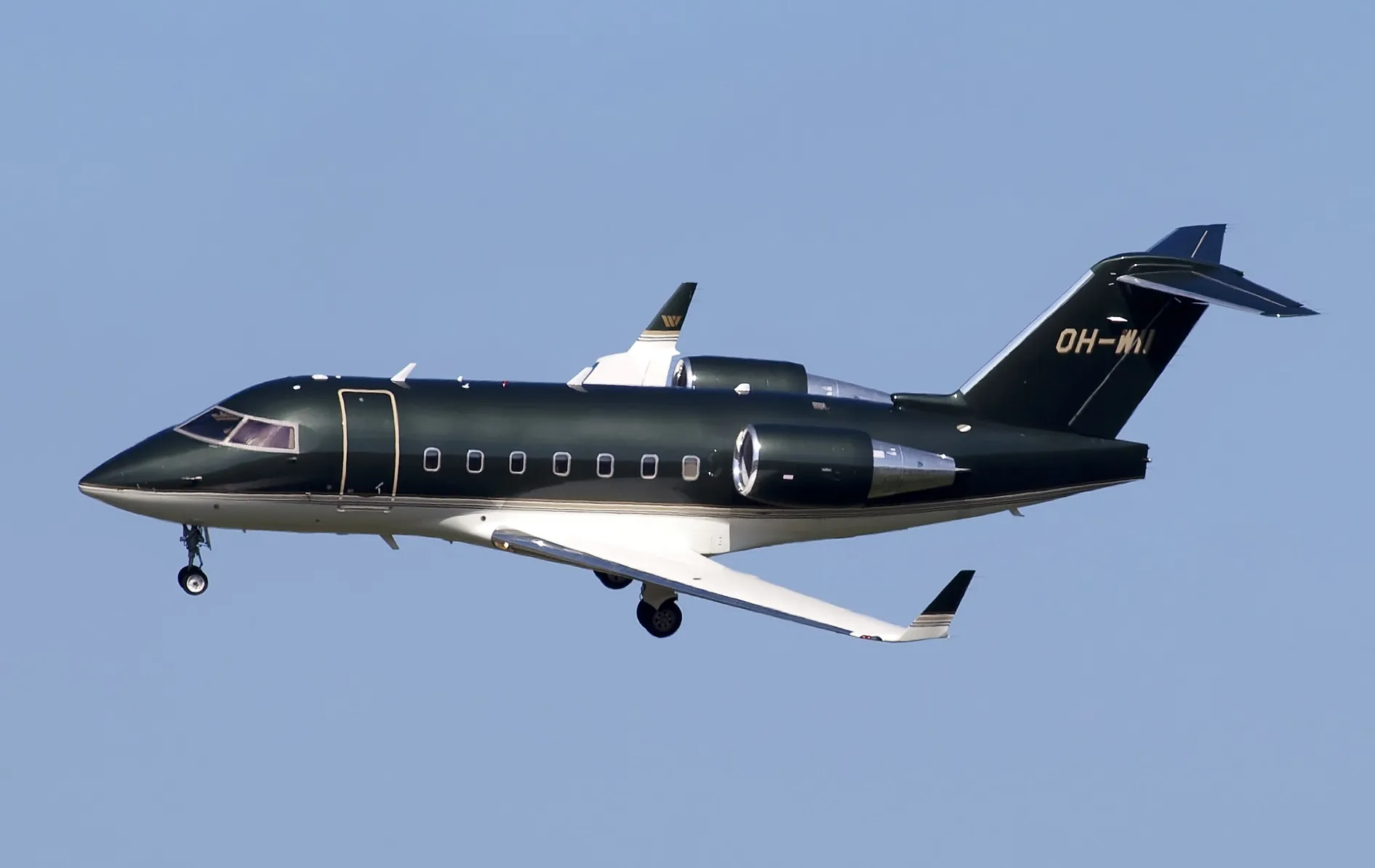 Business jet in flight above the clouds